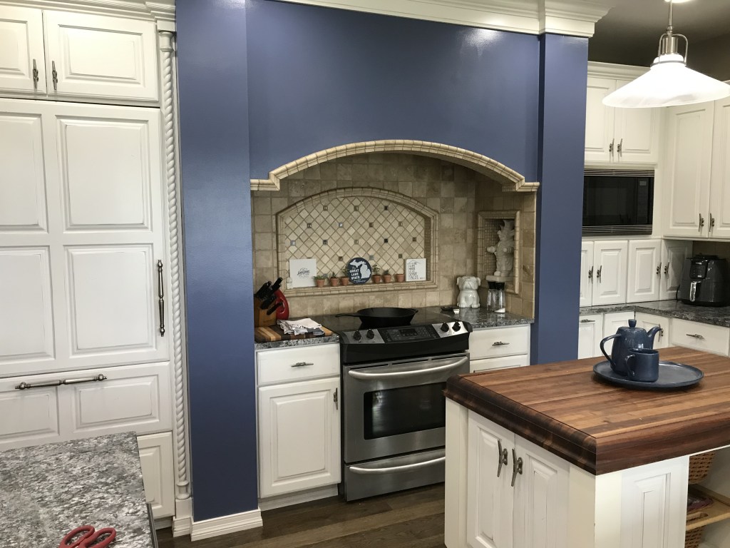 Kitchen wall recently finished being painted blue. 