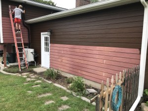 Men painting the outside of a house in Coldwater, MI. 