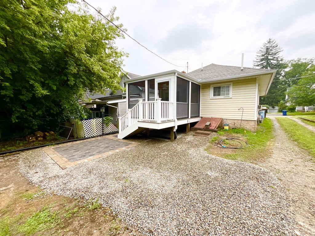 The new porch with the siding, screens, doors, steps, and patio all complete. 