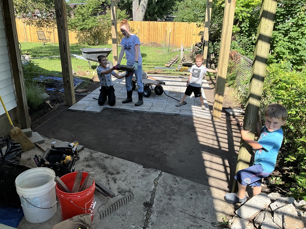 Boys watching the construction of the patio. 